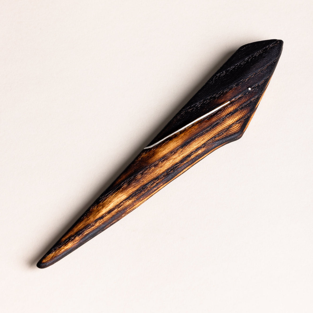 A front view of the Ash Sgian Dubh with a burnt finish and silver inlay against a white background.